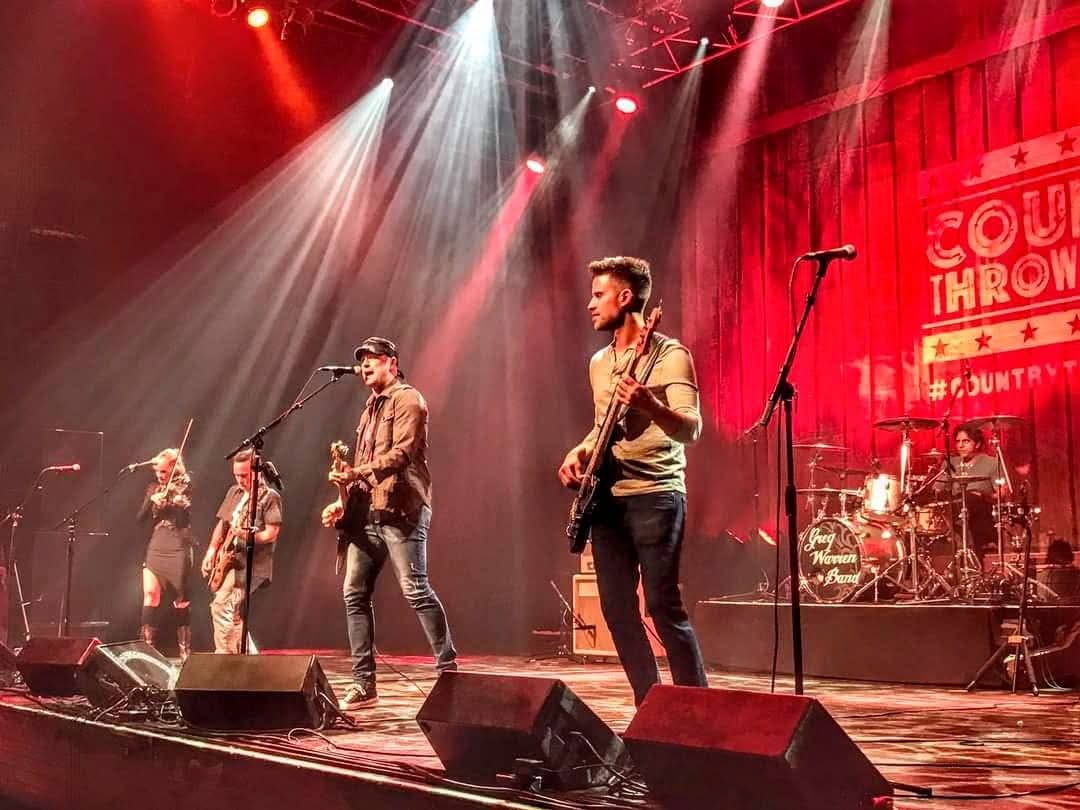 Greg Warren Band performing live on a big stage with dramatic red lighting at Country Throwdown